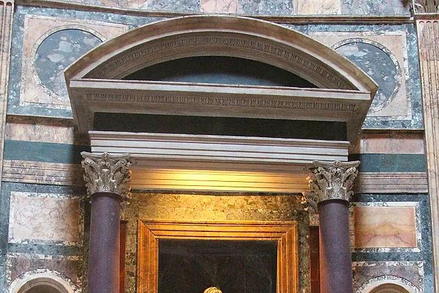 The Virgin and Child statue in the chapel niche, with Raphael's tomb below in an arched niche behind the barrier